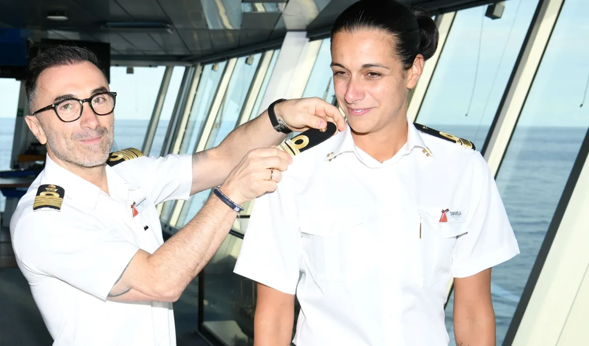 Captain Francesco Bencivenga places the epaulettes on Daniela Gargiulo mid