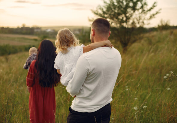 Cute family playing in a summer field
