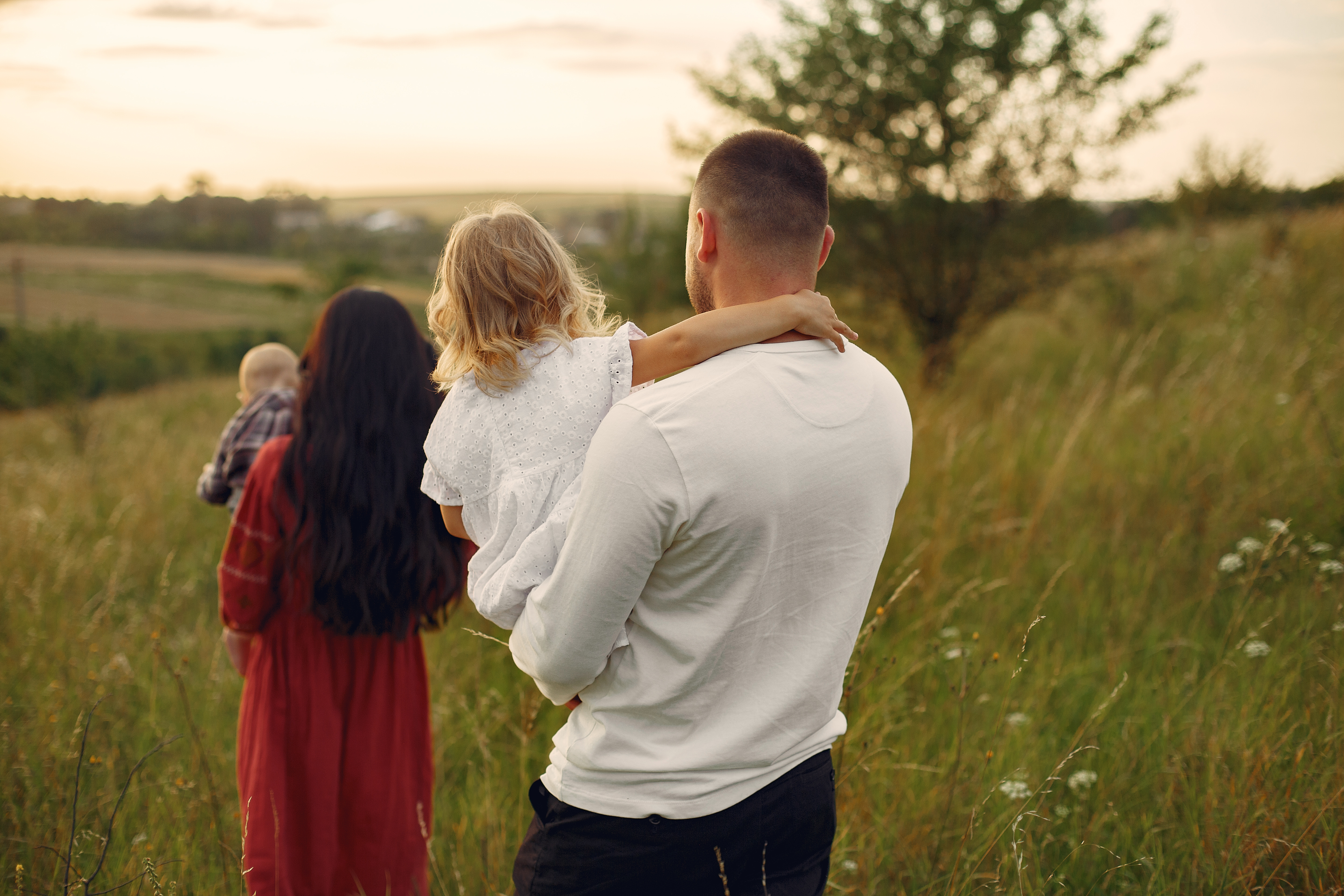 Cute family playing in a summer field
